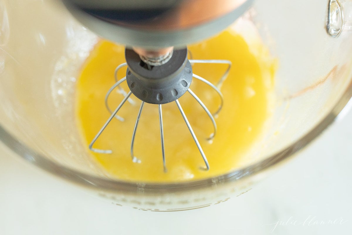 ingredients for a pumpkin bundt cake recipe in a stand mixer bowl.