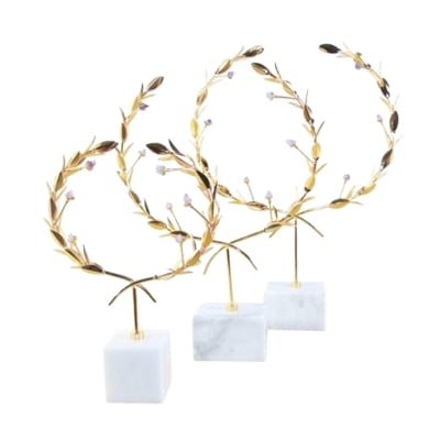 Three gold medallions with laurel wreaths on a white marble base.