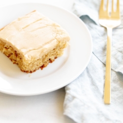 A slice of peanut butter cake on a white plate.