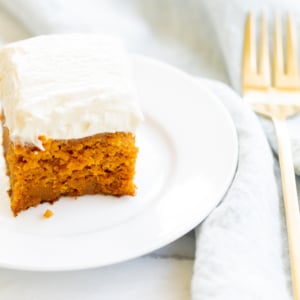 A slice of pumpkin cake on a plate.