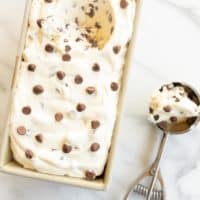 Chocolate chip ice cream in a loaf pan and an ice cream scoop