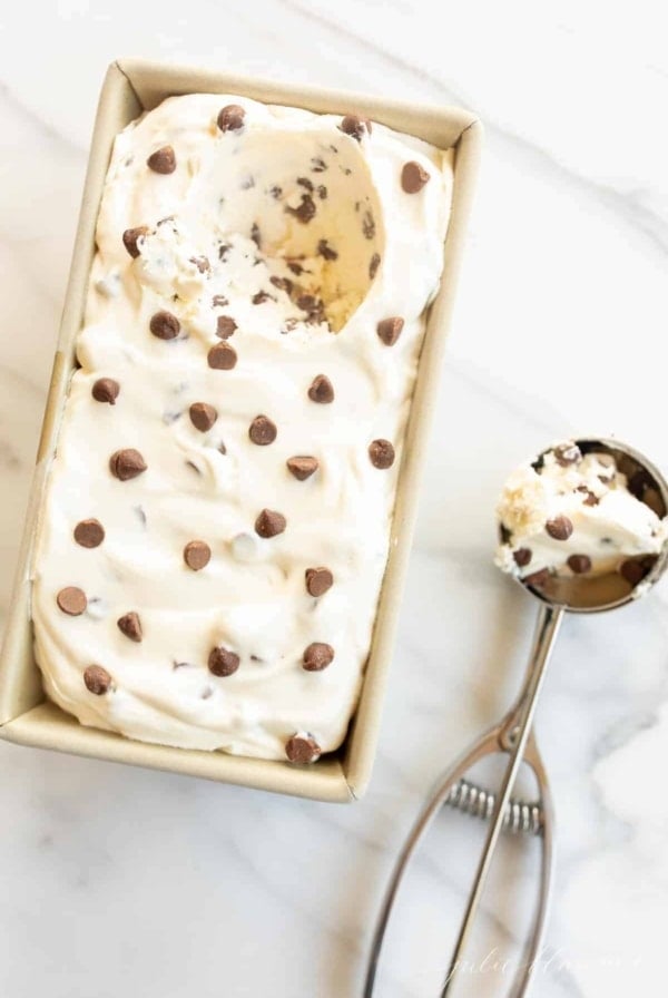 Chocolate chip ice cream in a loaf pan and an ice cream scoop