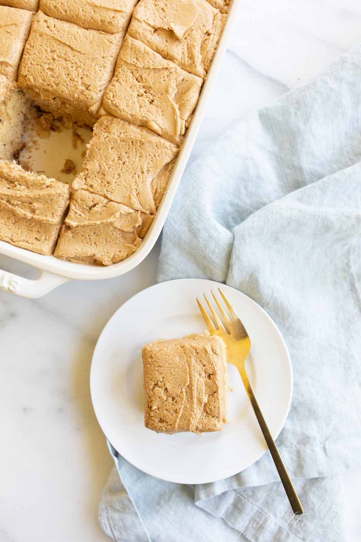 A piece of speculoos cake on a plate with a fork.