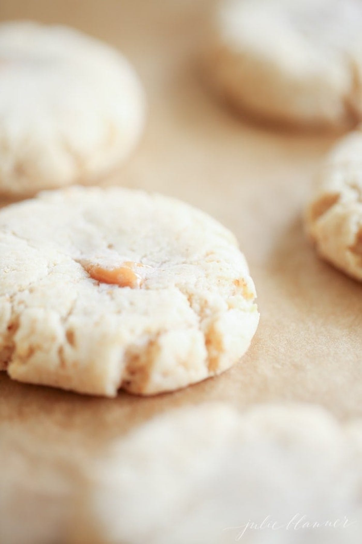 caramel stuffed cookies on a baking sheet