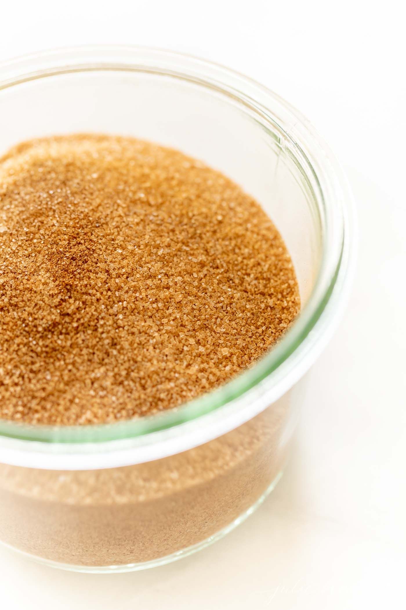 A small glass jar full of a homemade cinnamon sugar recipe.