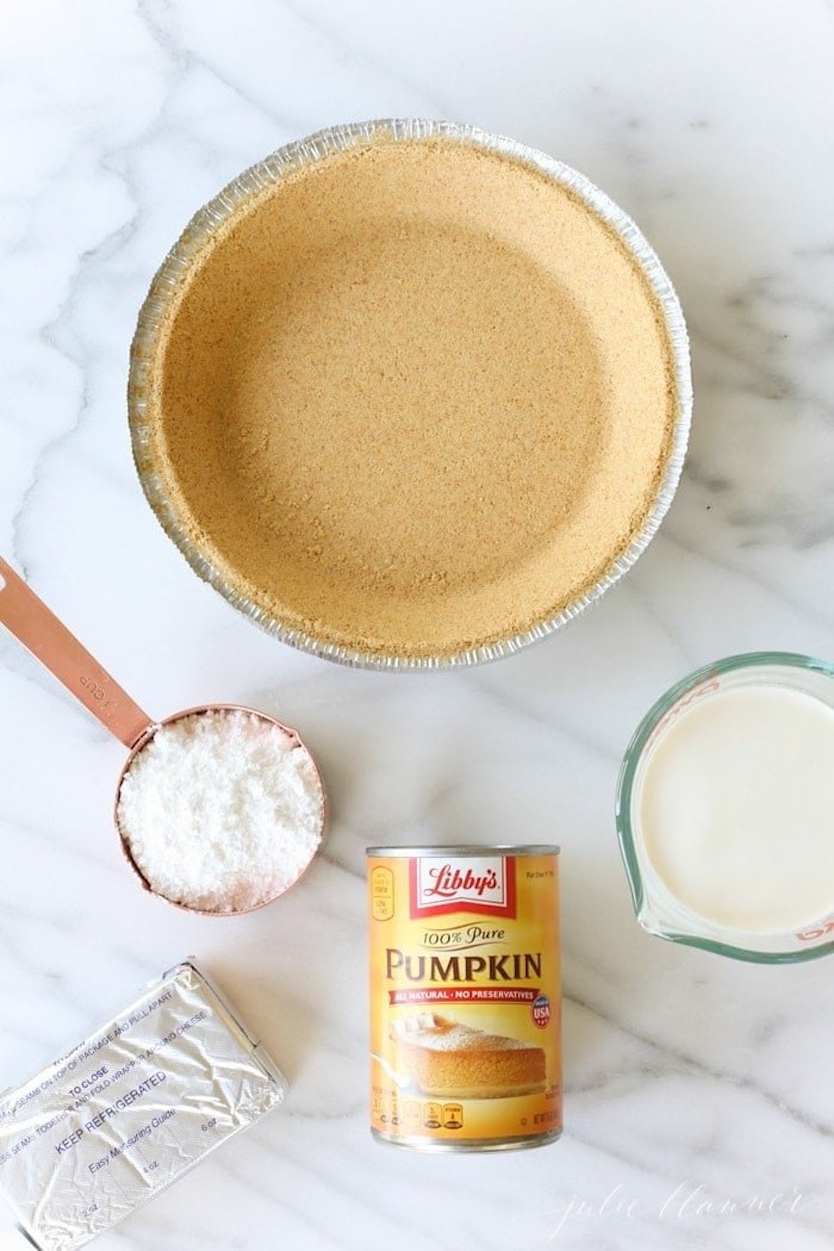 graham cracker crust, powdered sugar, cream cheese, can of pumpkin puree, and heavy cream
