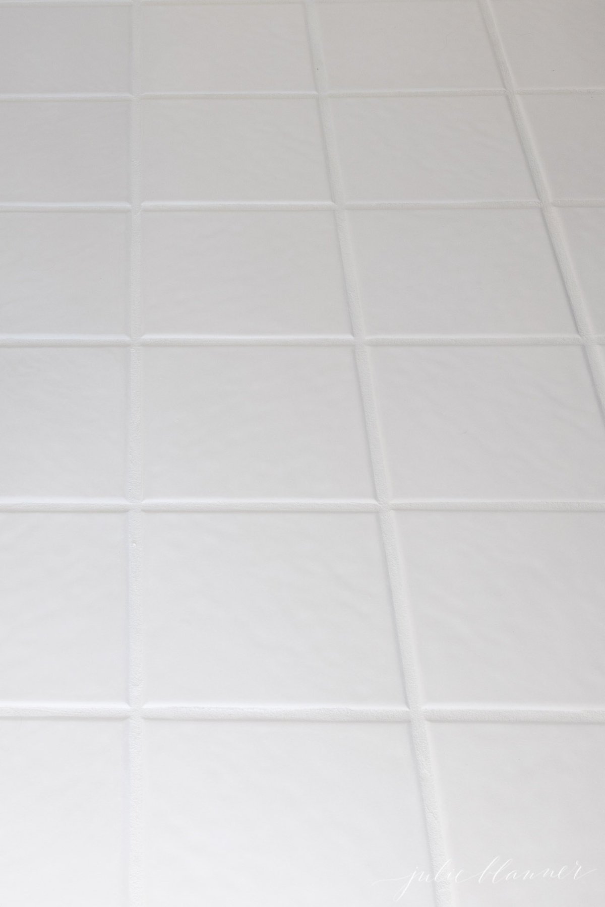 White tile with the grout lines refreshed with Polyblend Grout Renew.