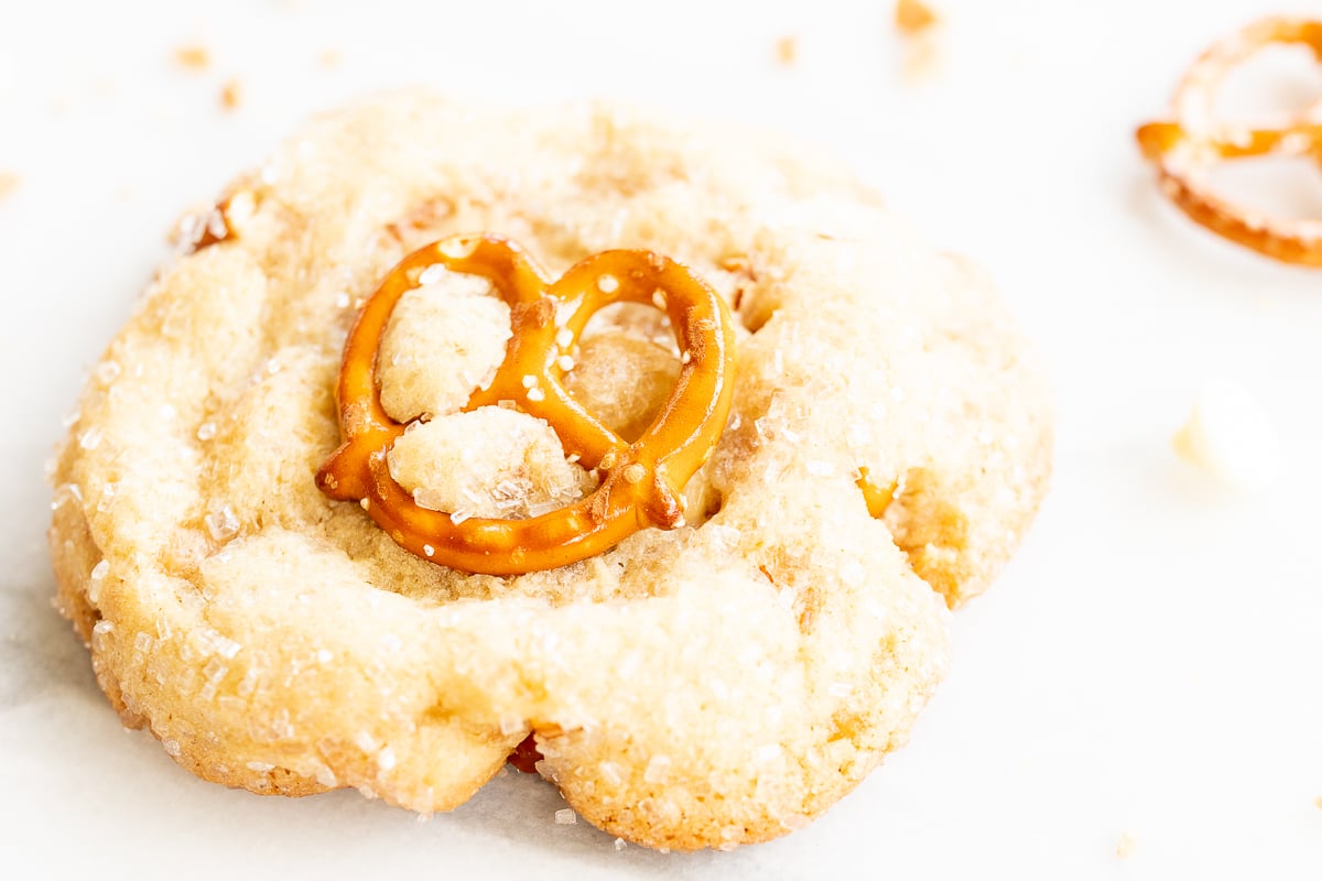 Kitchen sink cookies with pretzels, white chocolate and toffee on a baking sheet.