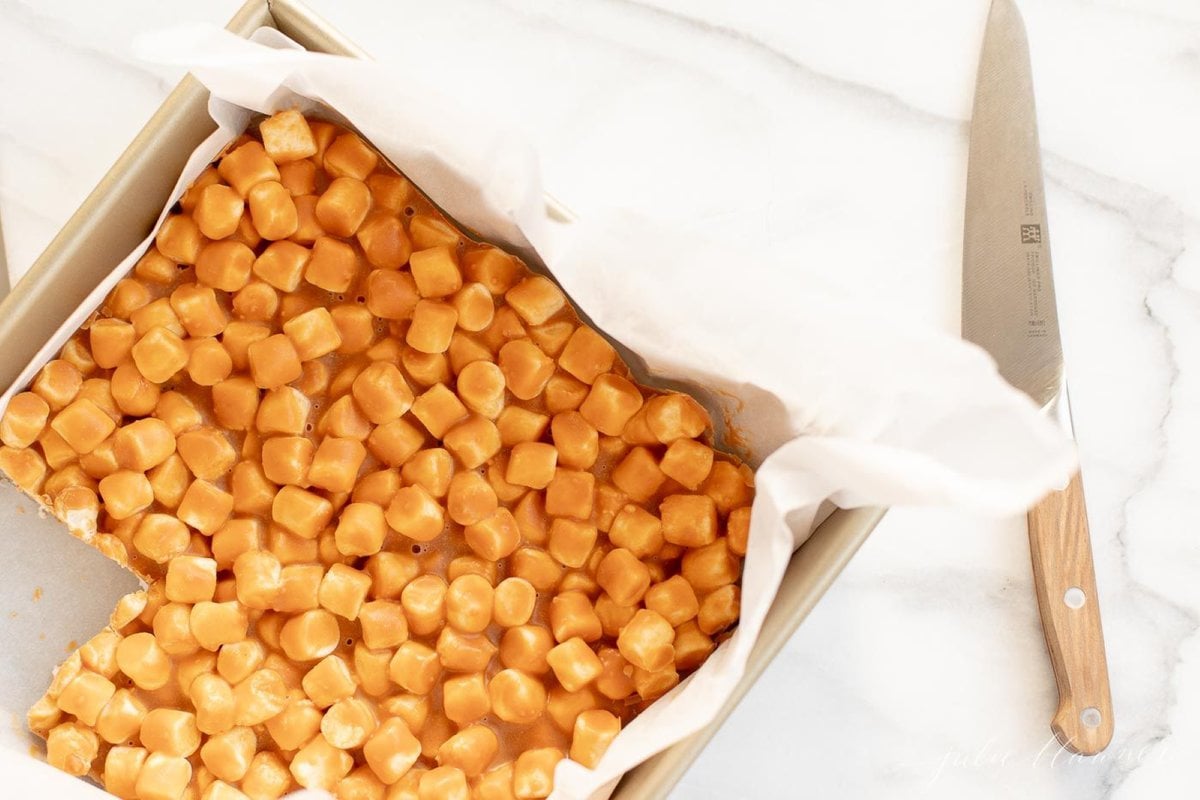 A gold cake pan full of butterscotch marshmallow bars