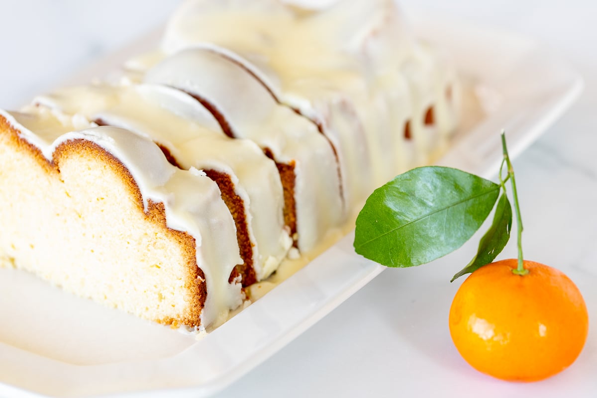 An orange pound cake recipe topped with glaze.