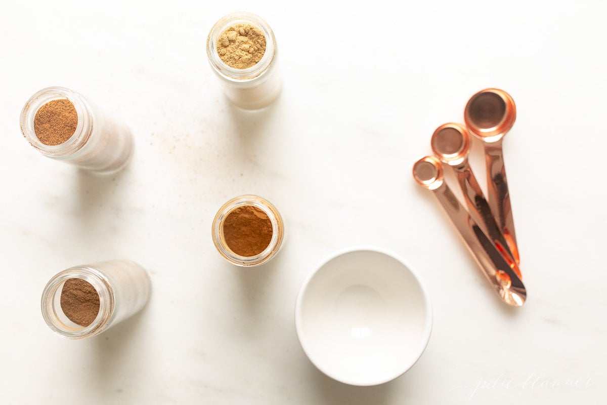 ingredients for pumpkin pie spice on a white countertop. 