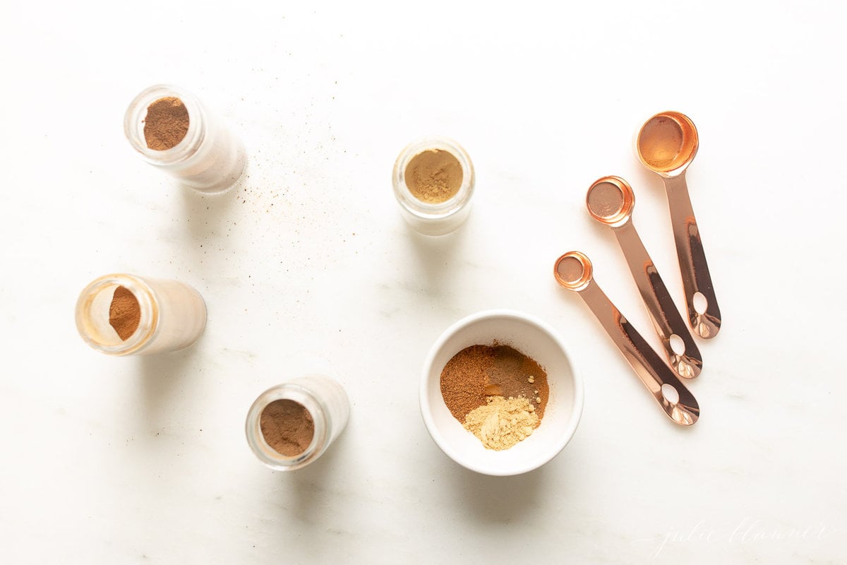 ingredients for pumpkin pie spice on a white countertop.