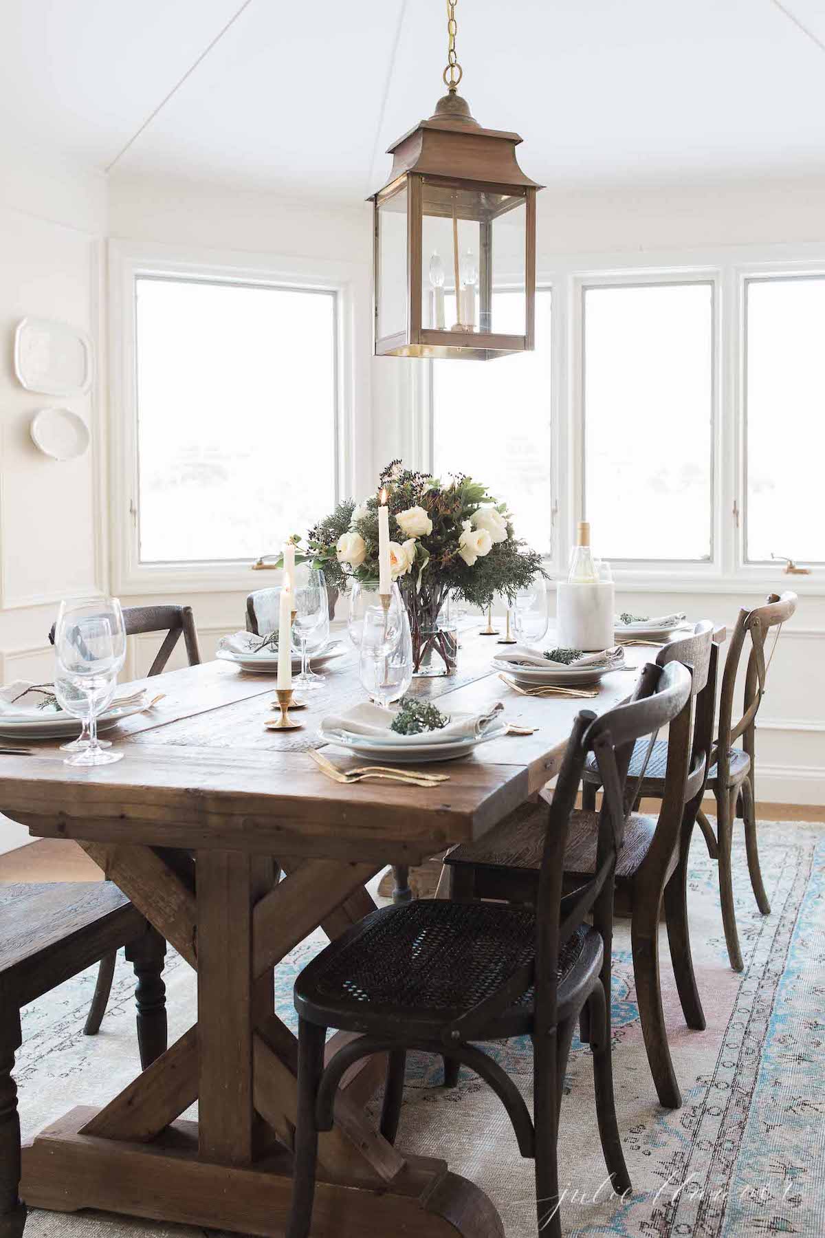 A dining room with a wooden table and chairs.