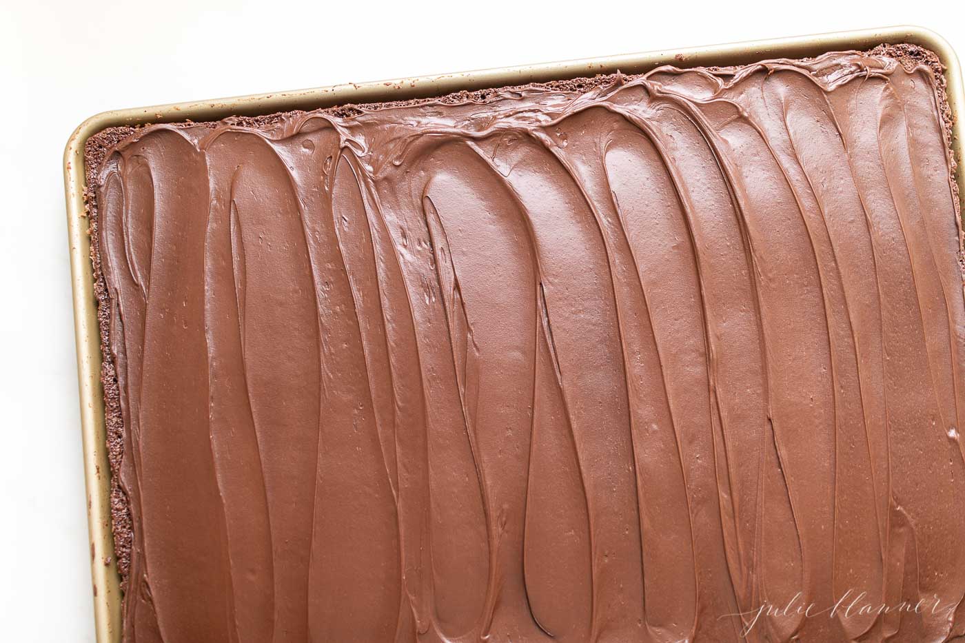 Christmas brownies in a sheet pan, covered in choolate frosting.