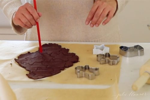 poking holes into cinnamon dough with straw