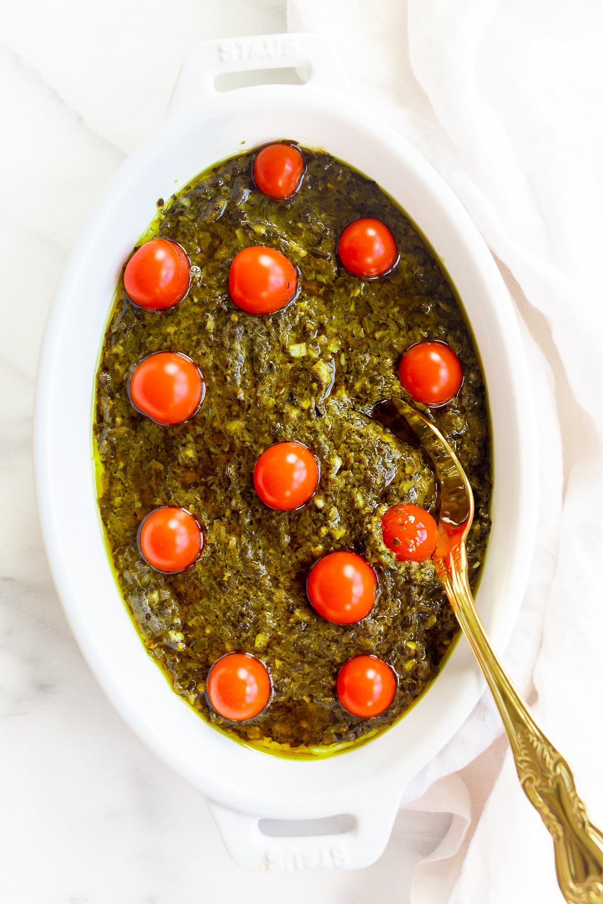 An easy appetizer dip filled with pesto and tomatoes.