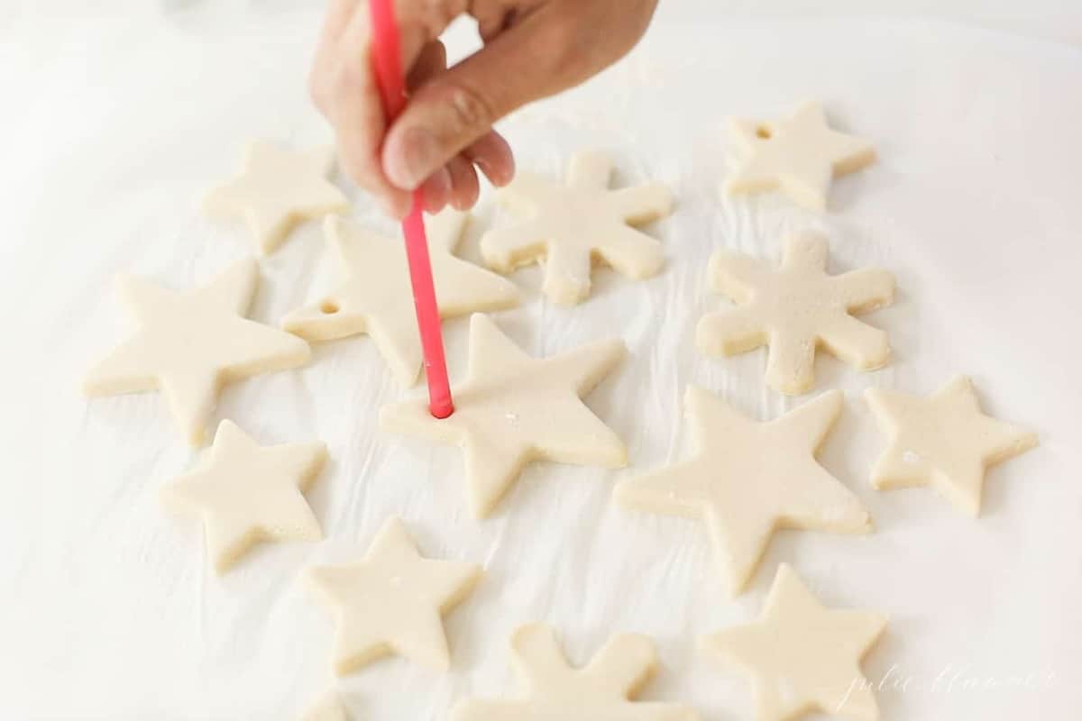 making a hole in salt dough with a straw to hang on tree