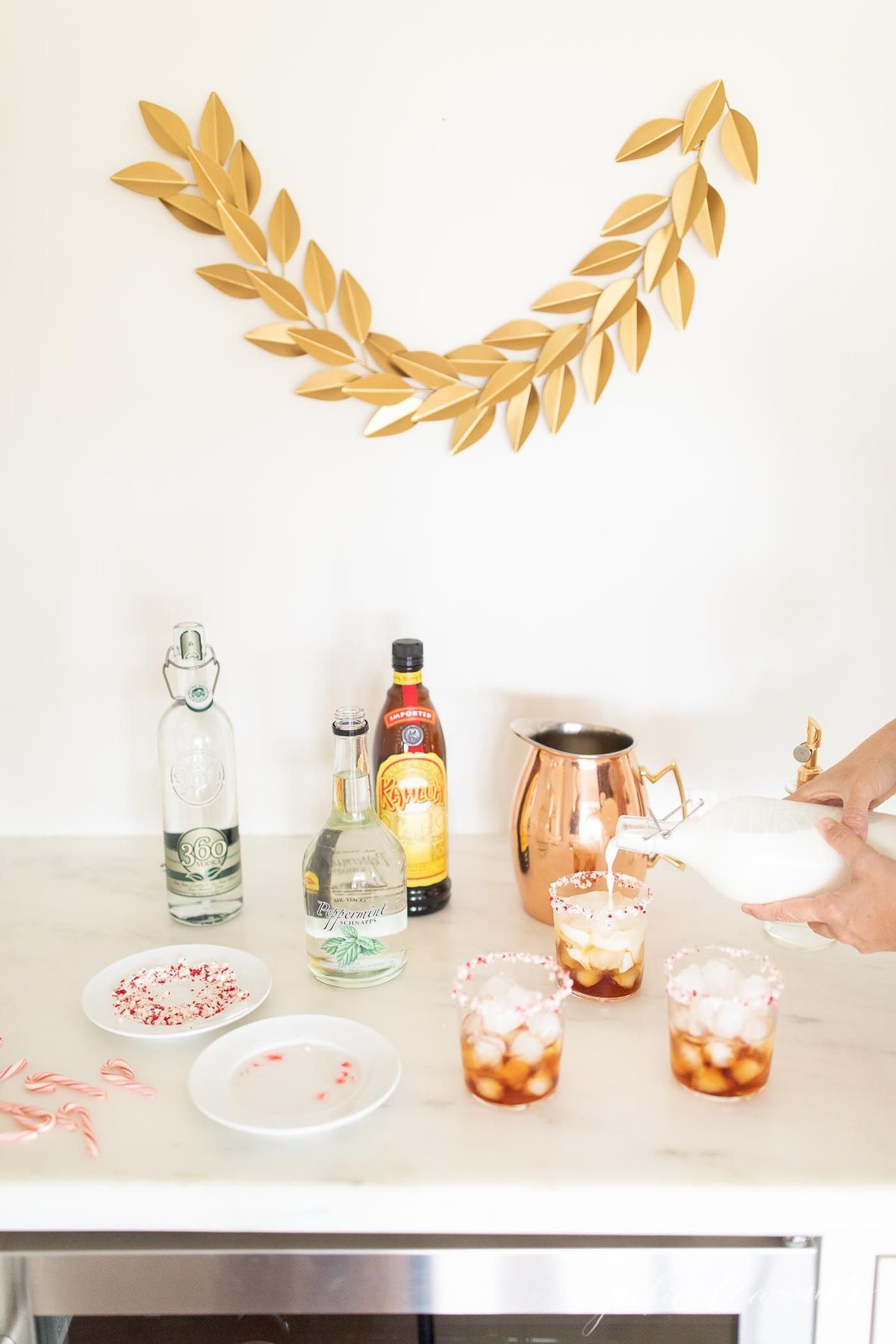 A bar set up for the holidays with ingredients for a Peppermint White Russian Cocktail.