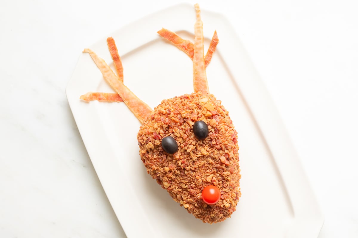 A reindeer cheeseball on a plate.