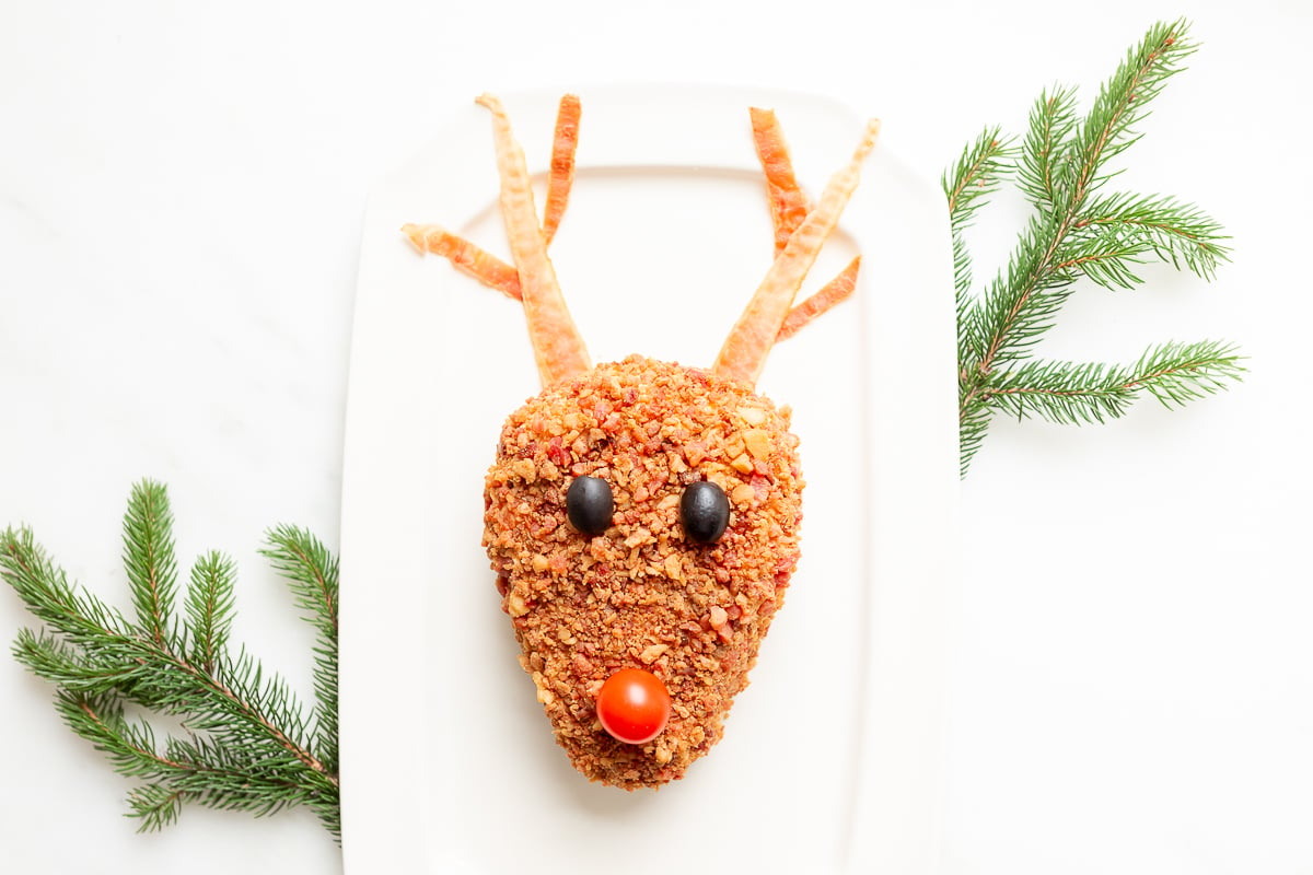 A plate with a reindeer head cheeseball.