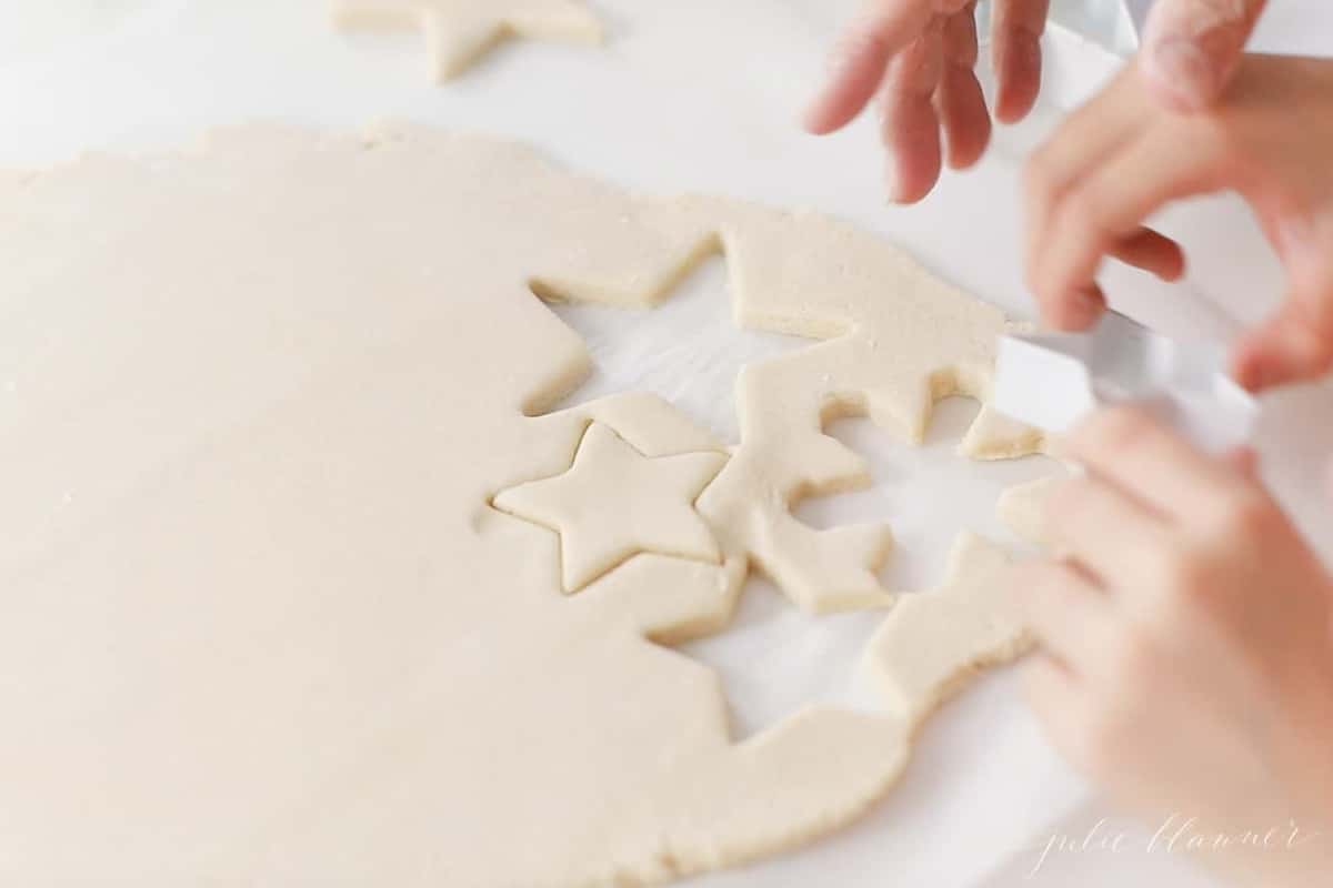 child cutting out salt dough ornaments