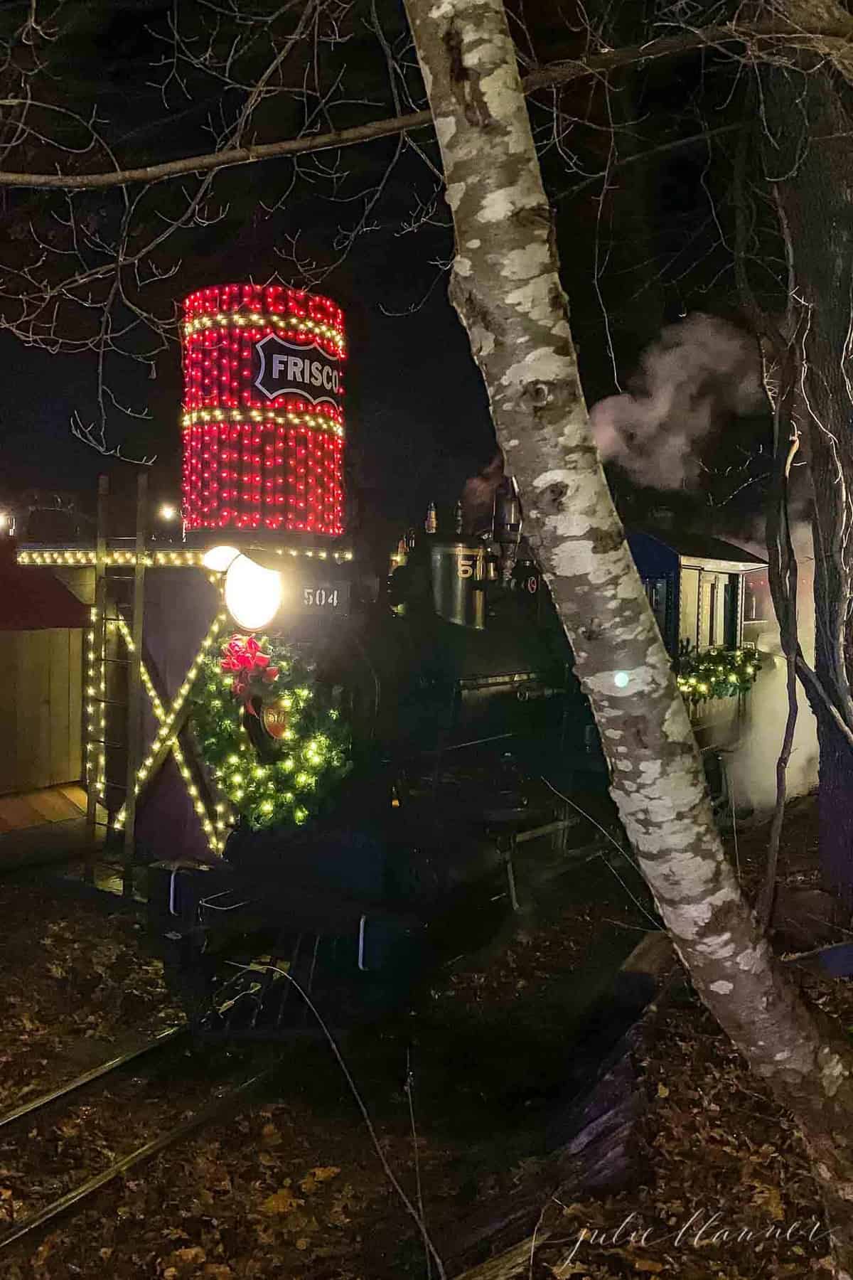 silver dollar city christmas train lit with a wreath on the engine