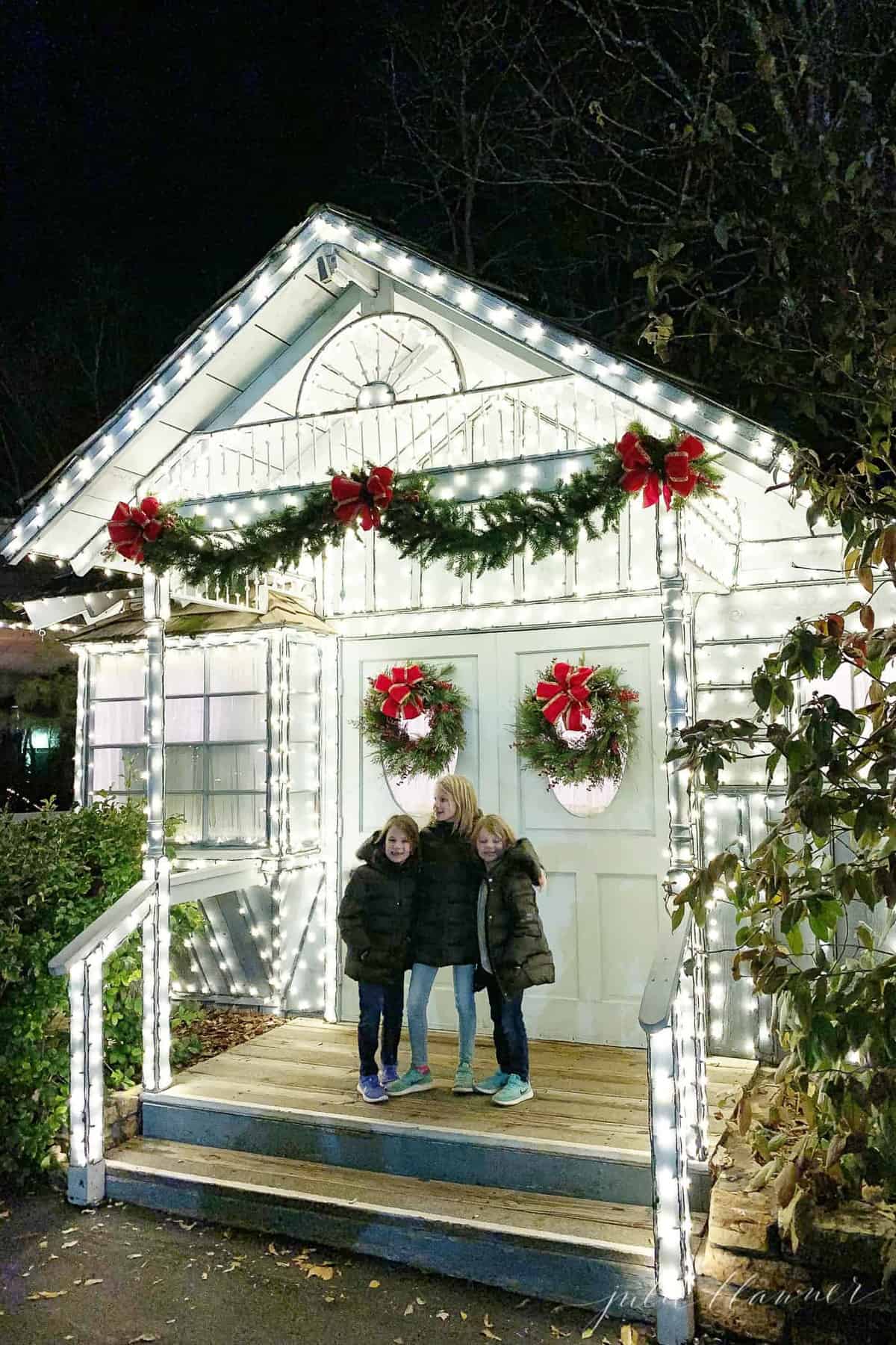 3 girls in front of building lined with lights at silver dollar city