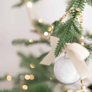 bath salt ornament hanging on tree with lights