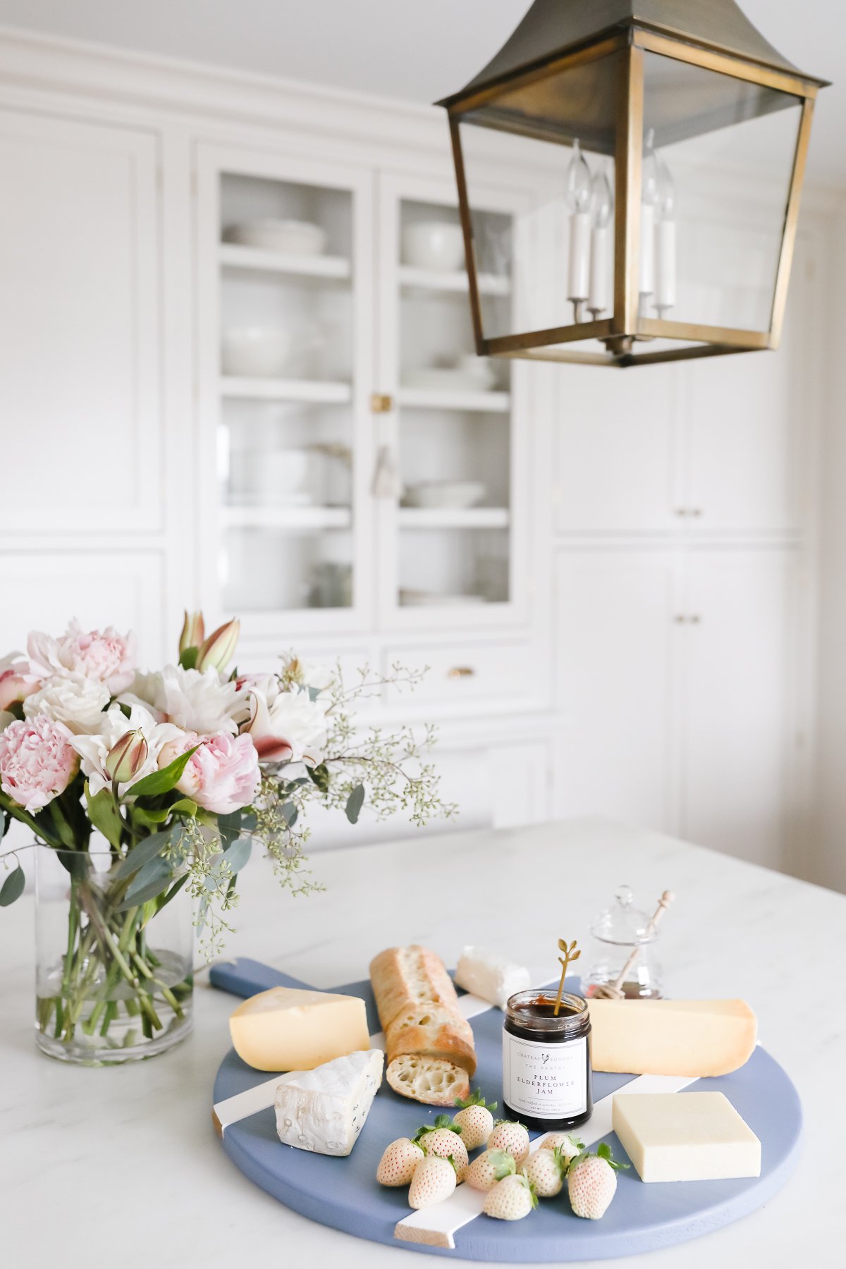 A blue cheeseboard with flowers in a hostess gift guide