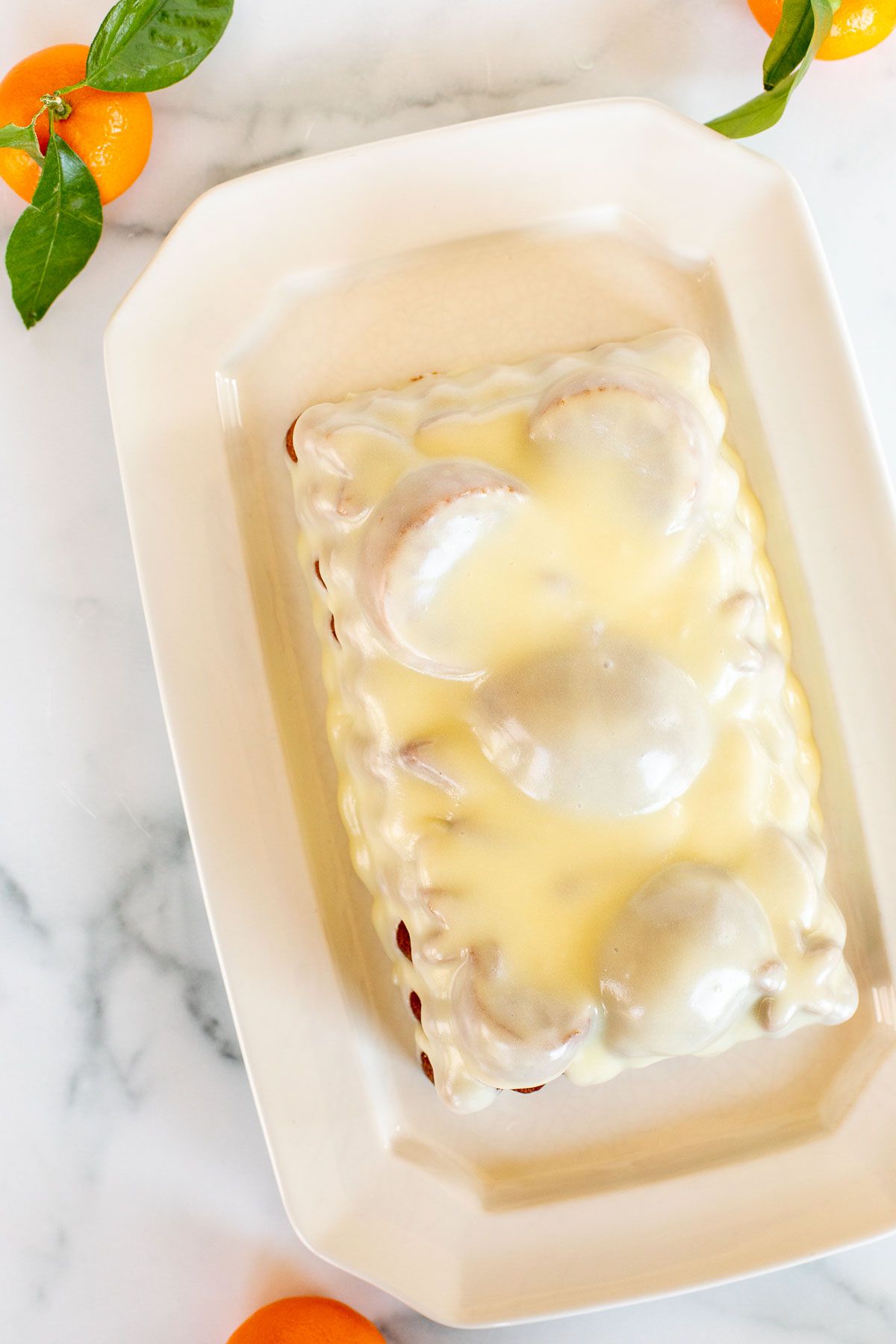 An orange pound cake covered in an orange glaze recipe.