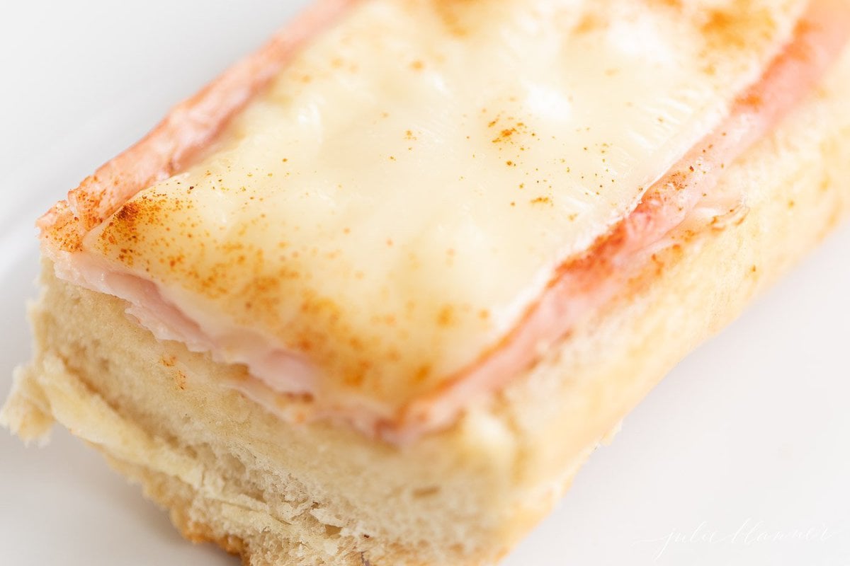 An open face gerber sandwich on a white plate