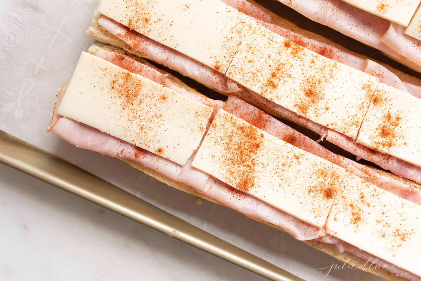 Gerber sandwiches on a parchment lined baking sheet.