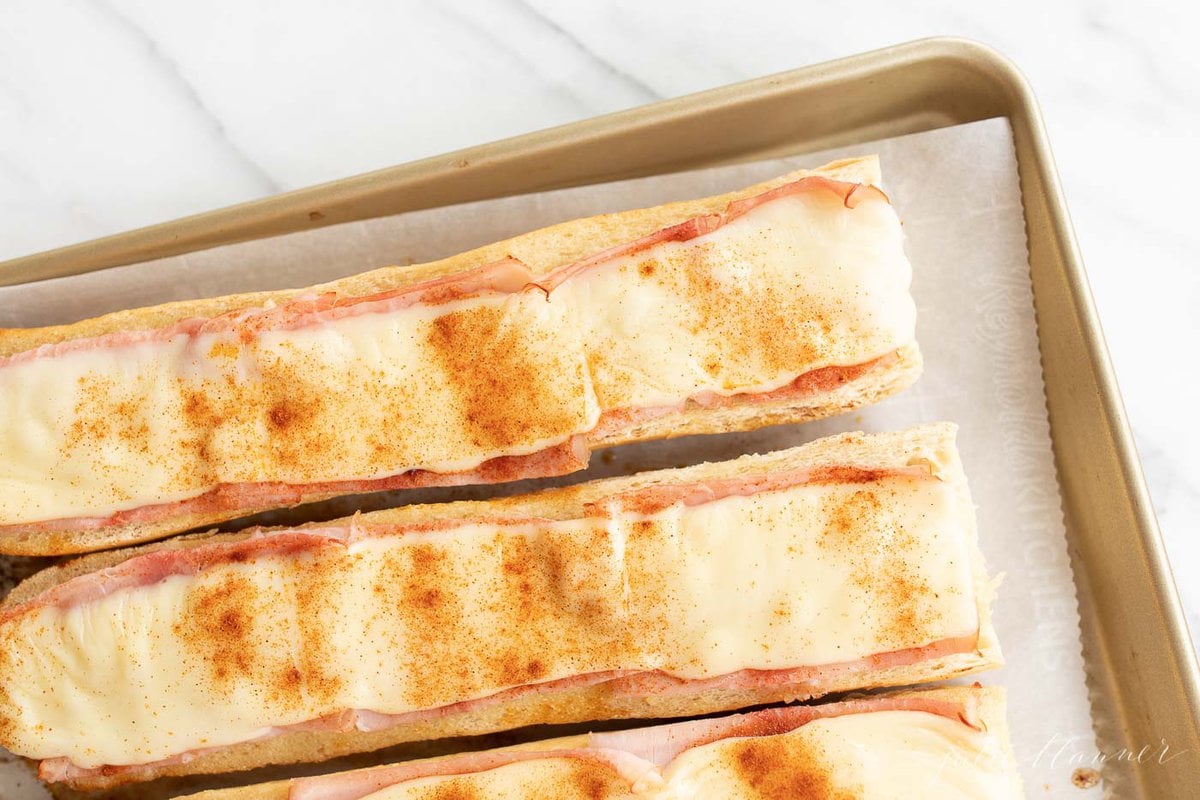 Gerber sandwiches on a parchment lined baking sheet.