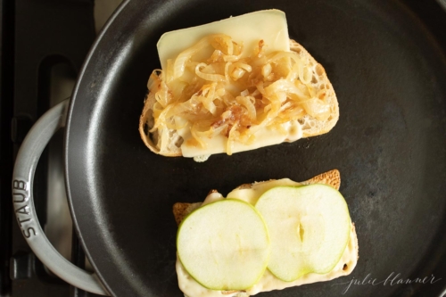 Bread with cheese slices on a stovetop pan for a gourmet grilled cheese.