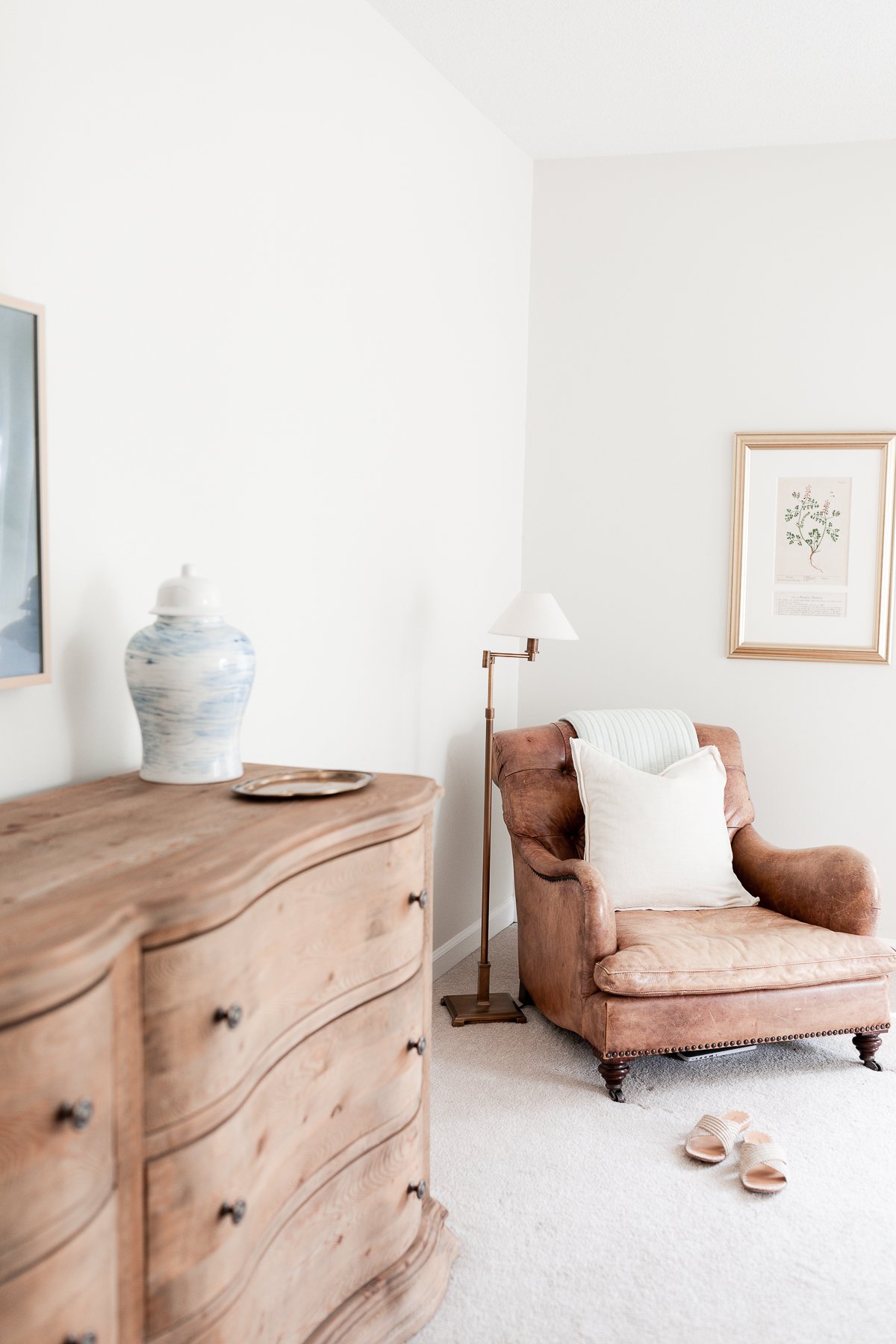 A primary bedroom in wood and cream tones with a minimalist design.