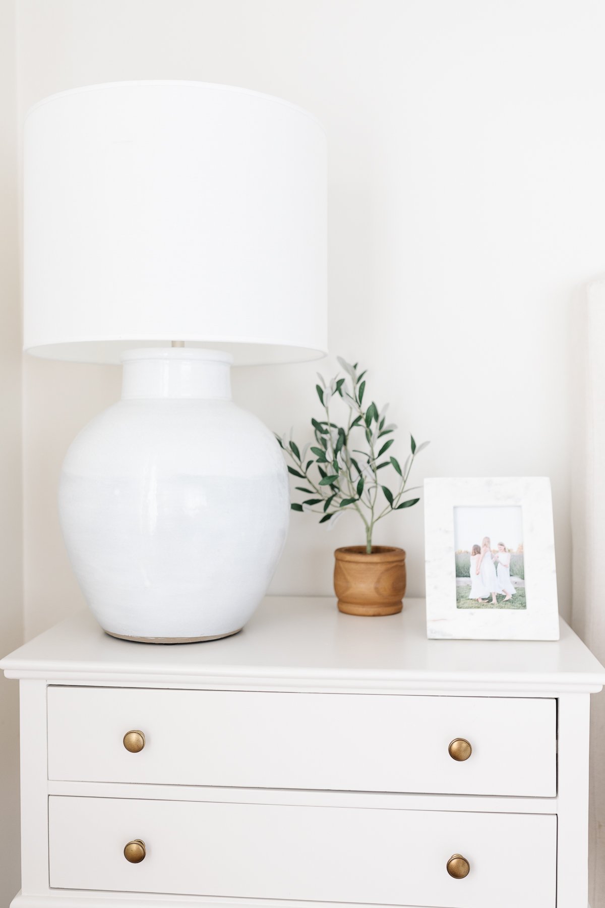 A primary bedroom in wood and cream tones with a minimalist design.