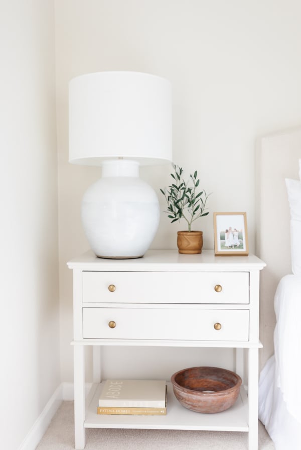 A primary bedroom in wood and cream tones with a minimalist design.