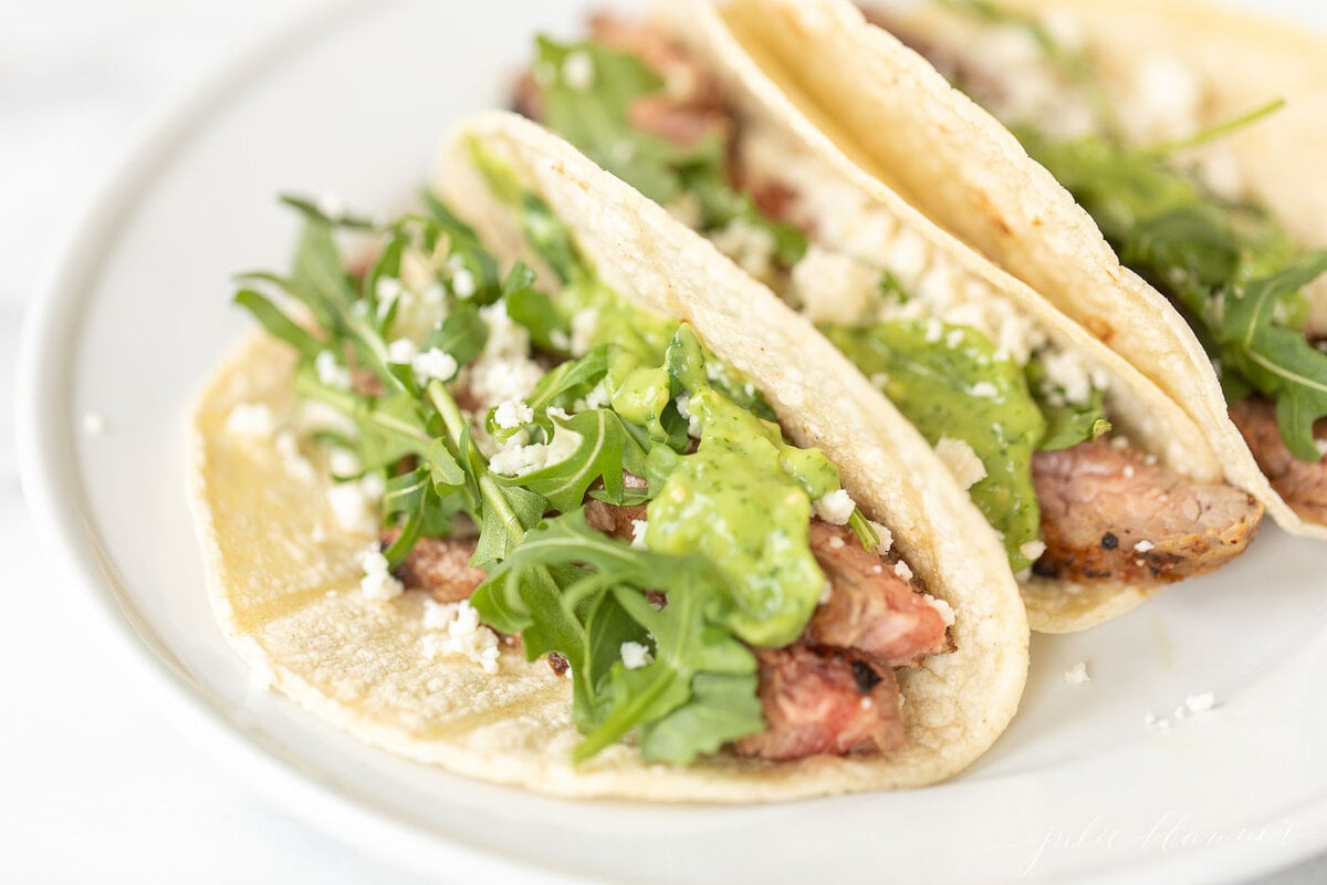 Steak tacos topped with salsa guacamole