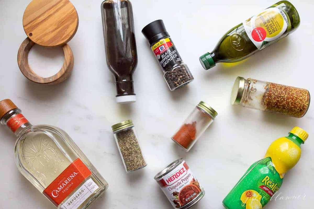 Ingredients for carne asada tacos laid out on a marble surface.