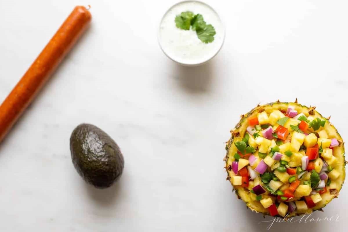 Ingredients for chorizo tacos laid out on a marble countertop