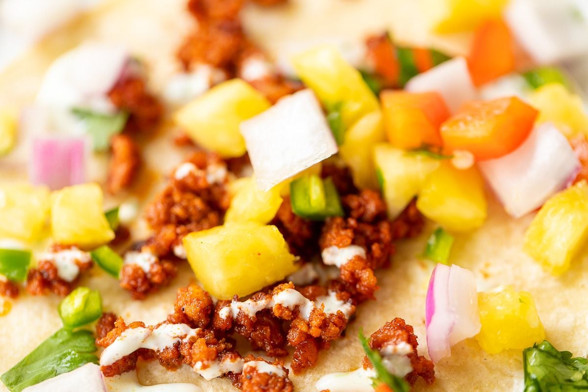 A chorizo taco topped with pineapple salsa