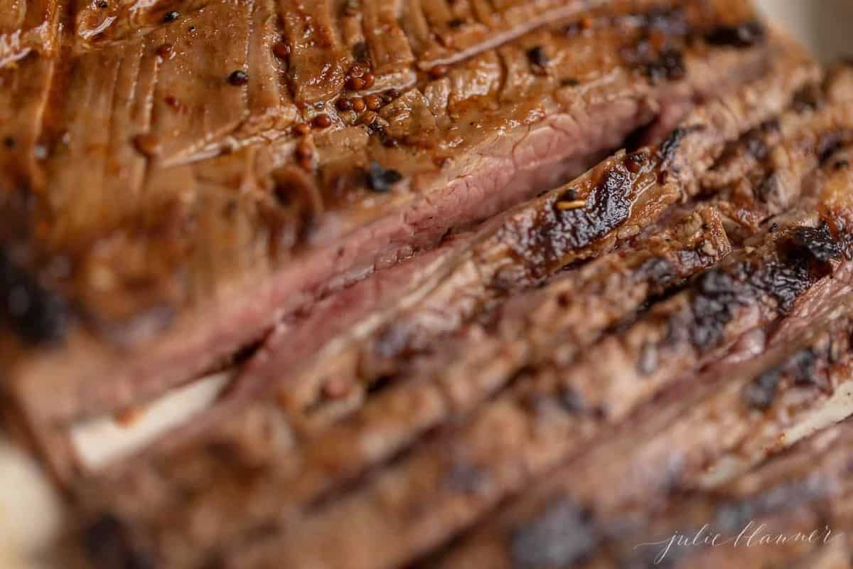 A close up of sliced flank steak after being cooked on the stove.