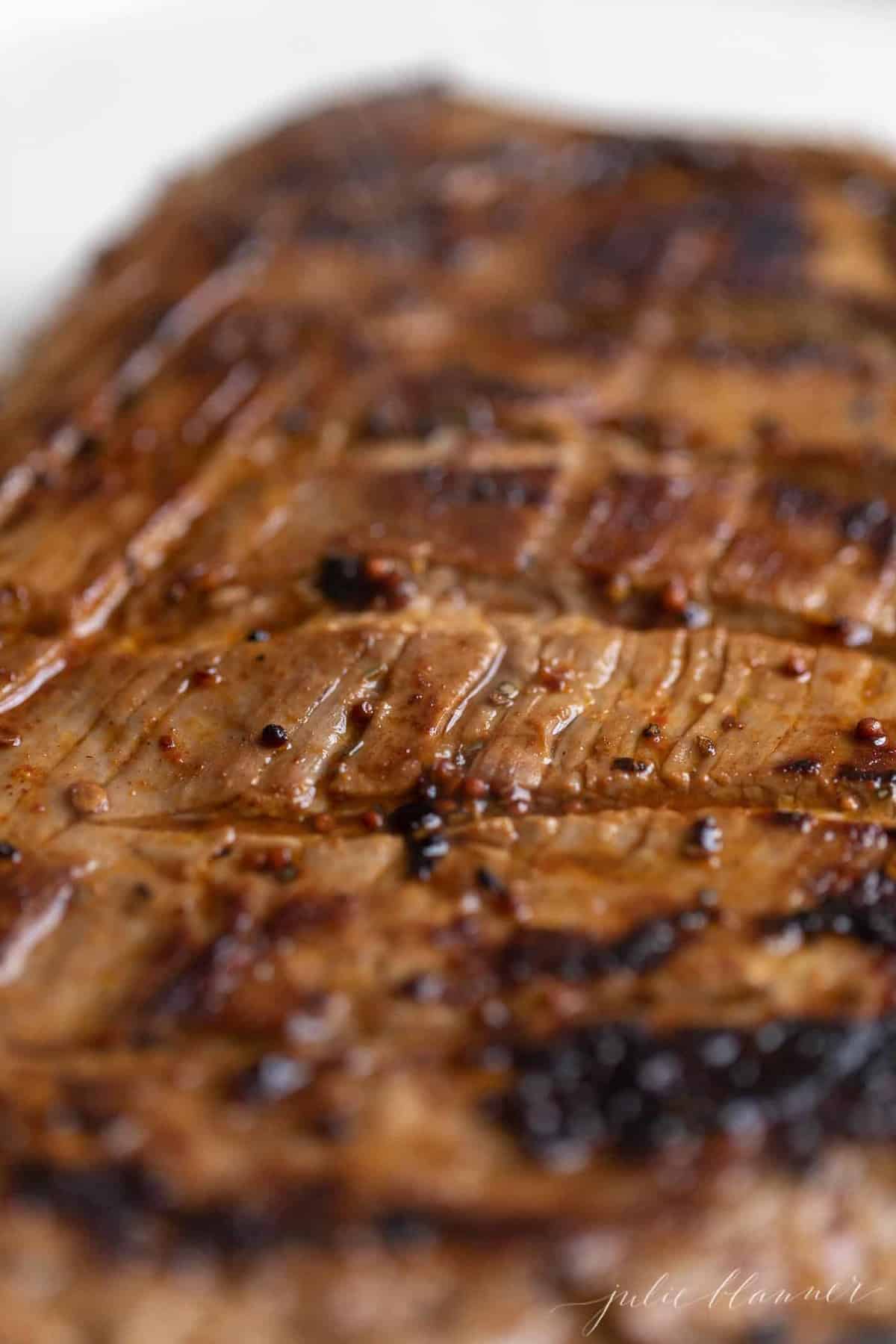 A close up of sliced flank steak after being cooked on the stove.