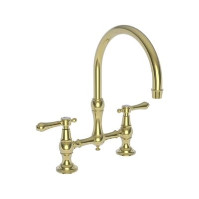 An unlacquered brass kitchen faucet against a white background.