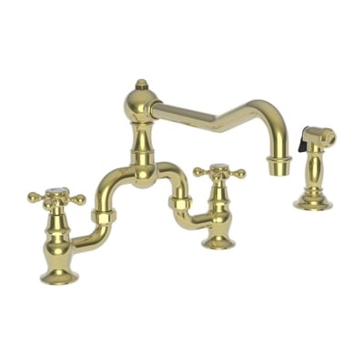 An unlacquered brass kitchen faucet against a white background. 