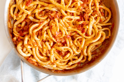 bucatini all'amatriciana in a skillet.