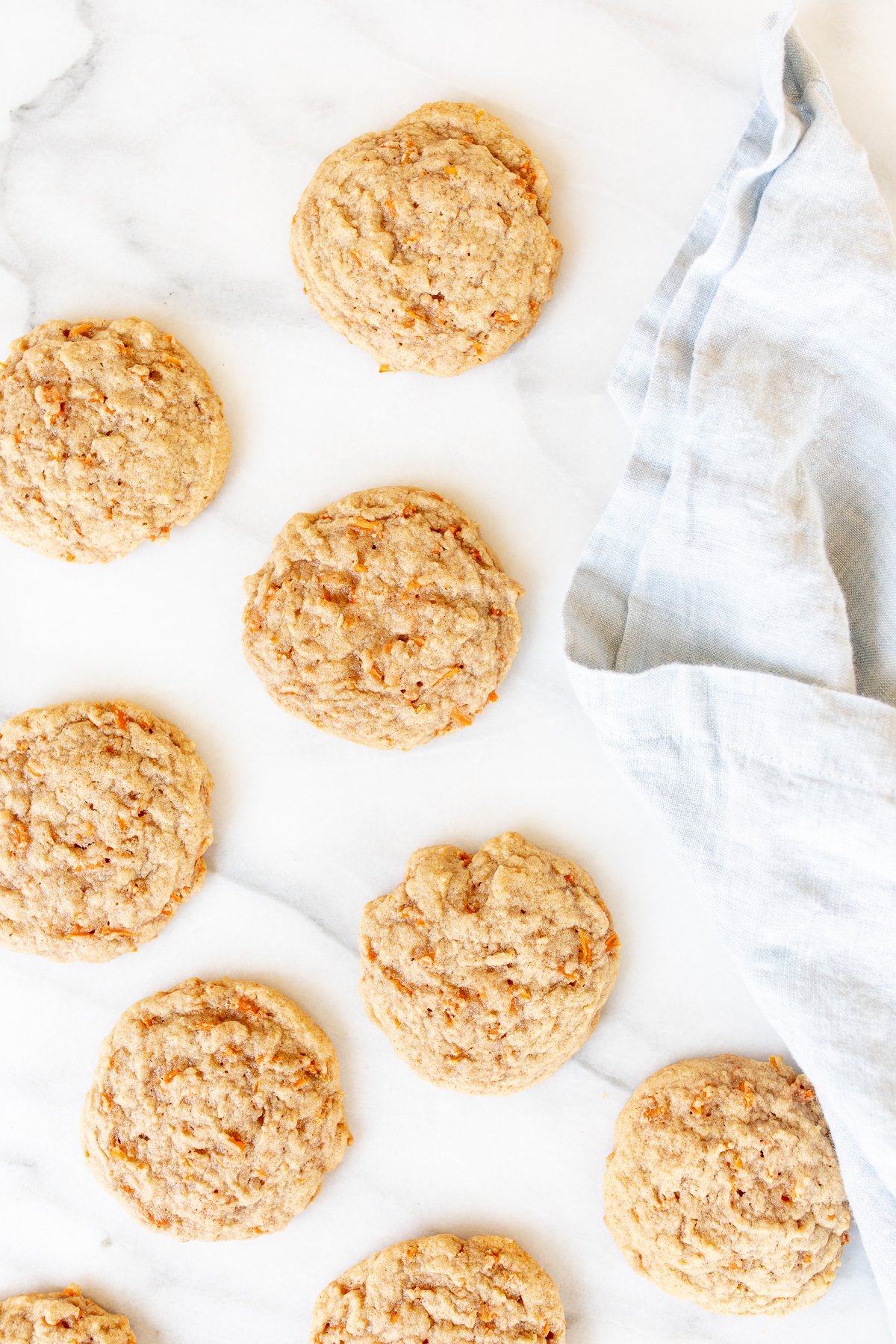 Carrot cake cookies on a marble countertop.