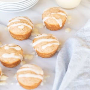 Carrot Cake Muffins with icing on a marble table.