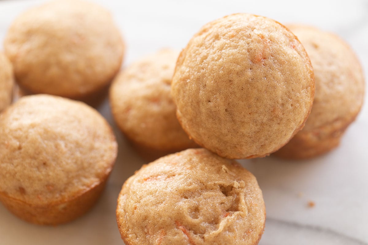 Carrot Cake Muffins on a marble countertop.