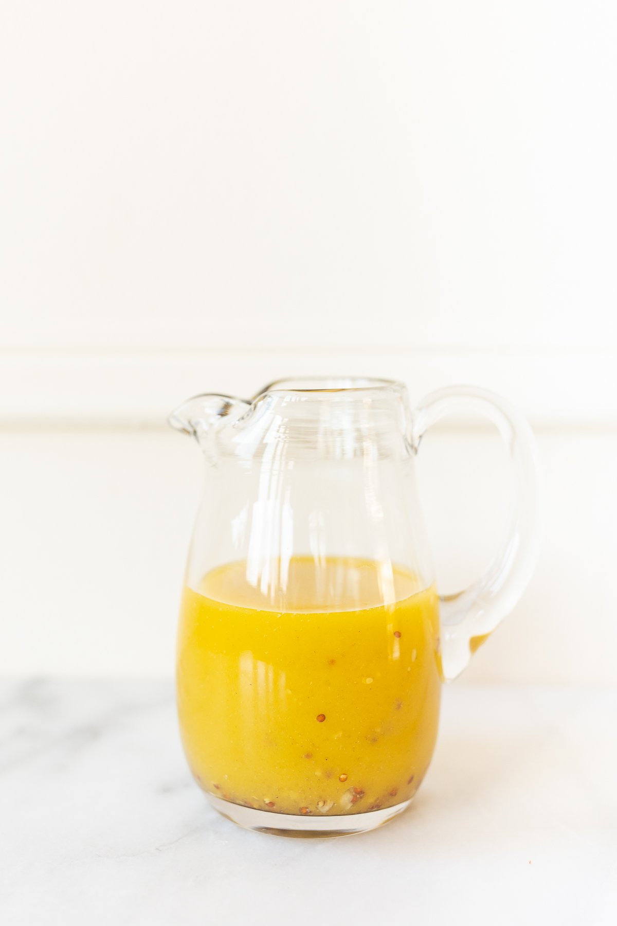 Champagne vinaigrette in a glass pitcher.